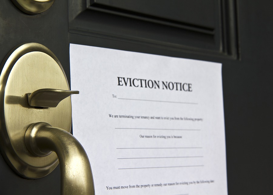 Eviction Notice taped to a door next to a door handle